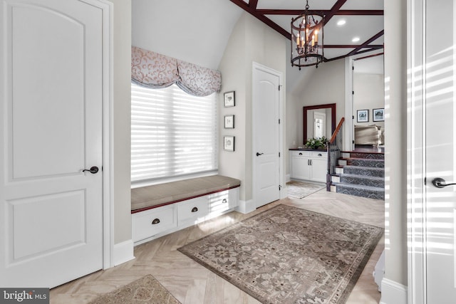 mudroom with light parquet floors and a chandelier