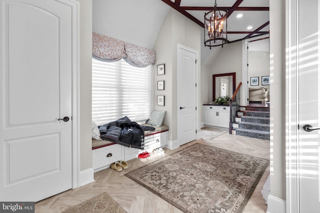 entryway featuring light parquet floors, vaulted ceiling, and an inviting chandelier