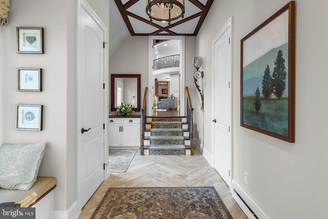 foyer entrance featuring vaulted ceiling and baseboard heating