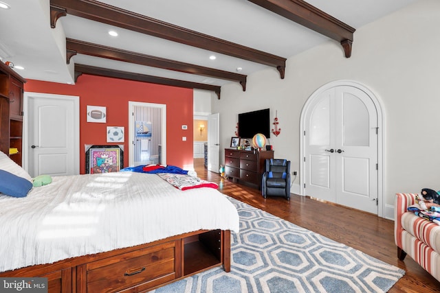 bedroom featuring beamed ceiling and dark wood-type flooring