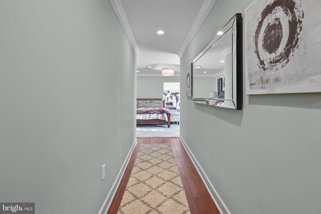 corridor featuring hardwood / wood-style flooring and crown molding