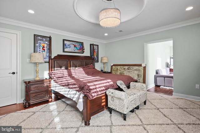 bedroom featuring wood-type flooring and crown molding