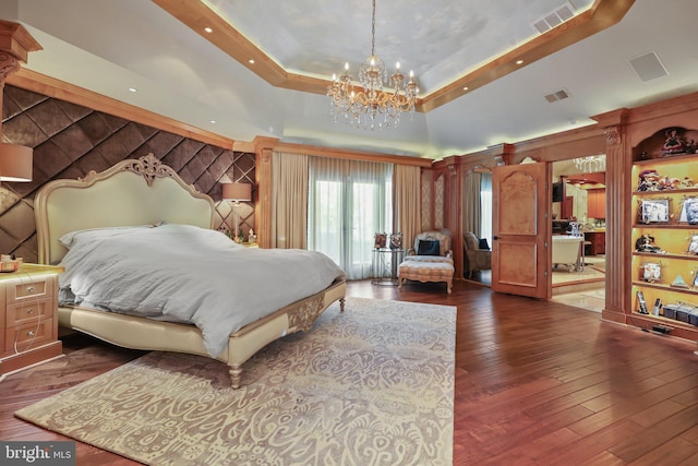 bedroom with a raised ceiling, vaulted ceiling, dark hardwood / wood-style floors, and a notable chandelier