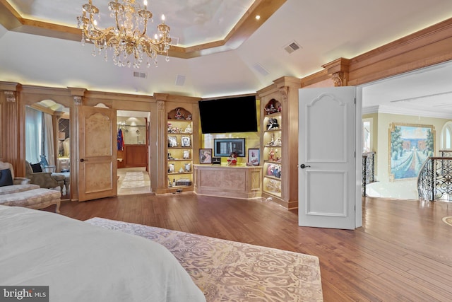 bedroom with hardwood / wood-style flooring and a chandelier