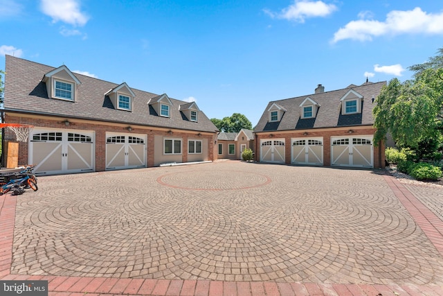 cape cod-style house featuring a garage