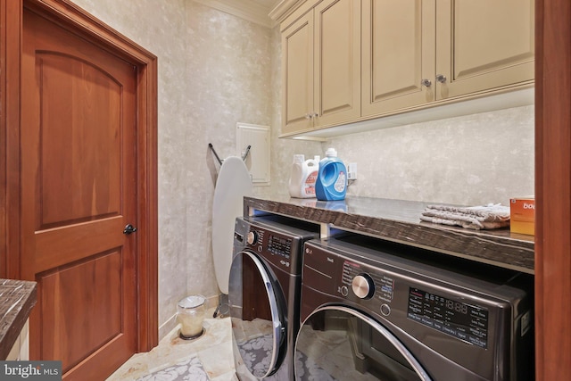 laundry area featuring cabinets, washer and dryer, and ornamental molding