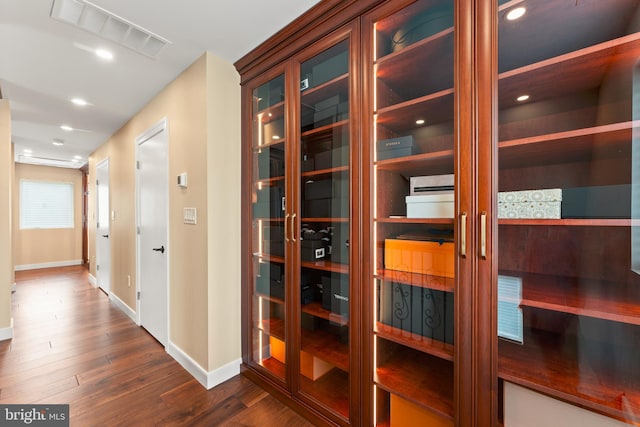 hallway featuring dark hardwood / wood-style floors