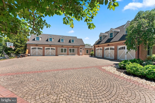 cape cod house featuring a garage