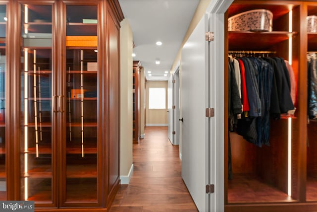 hallway with hardwood / wood-style flooring