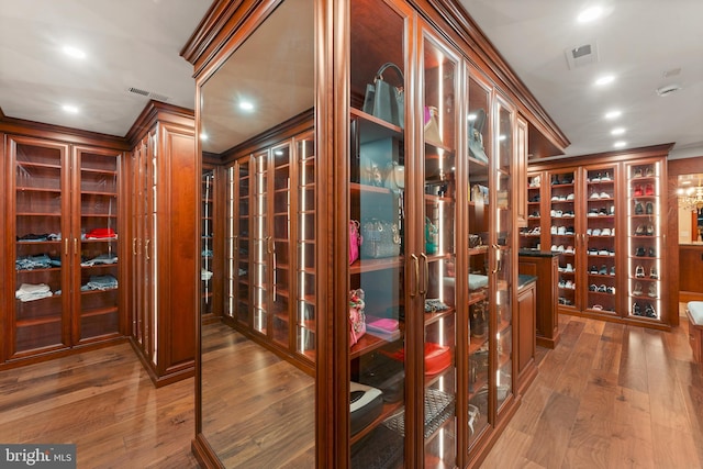 wine room featuring crown molding and dark wood-type flooring