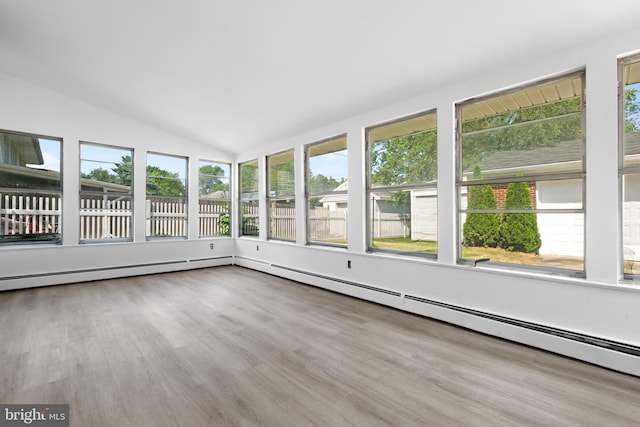 unfurnished sunroom with a baseboard radiator, a healthy amount of sunlight, and vaulted ceiling