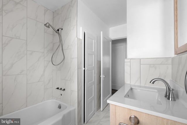 bathroom featuring vanity, tile walls, and tiled shower / bath