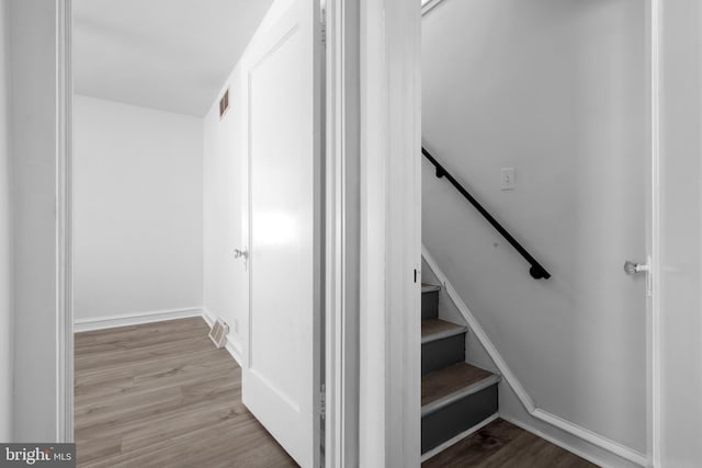 stairs with hardwood / wood-style flooring