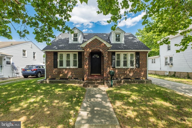 cape cod-style house with a front lawn