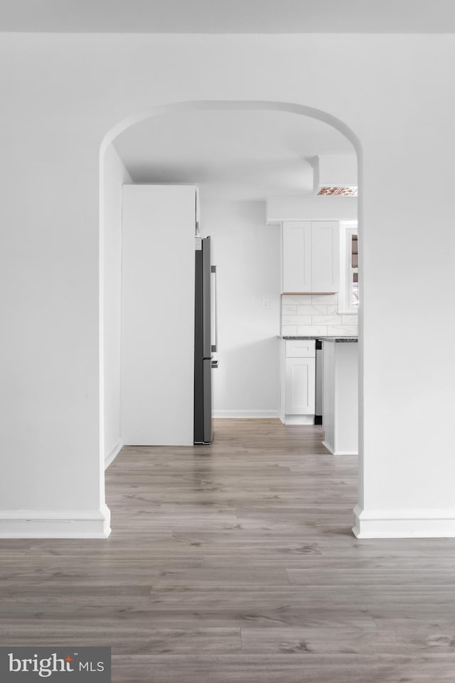 corridor with light hardwood / wood-style floors