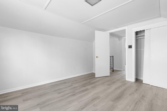 additional living space with light hardwood / wood-style floors