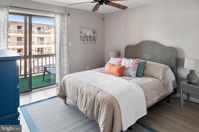 bedroom featuring access to outside, dark hardwood / wood-style floors, and ceiling fan