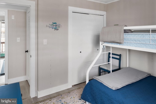 bedroom with light hardwood / wood-style floors and crown molding