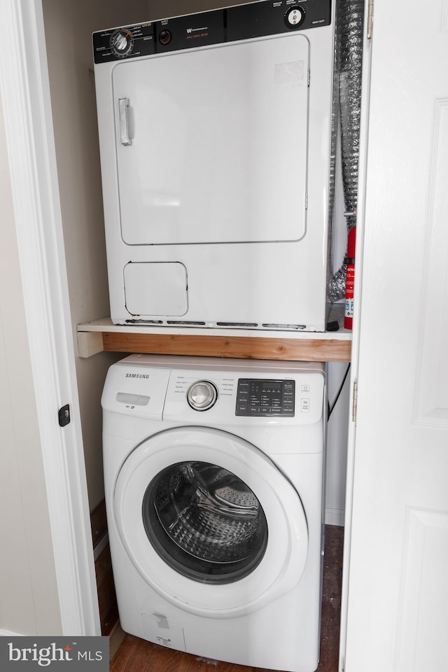 washroom featuring stacked washer and dryer