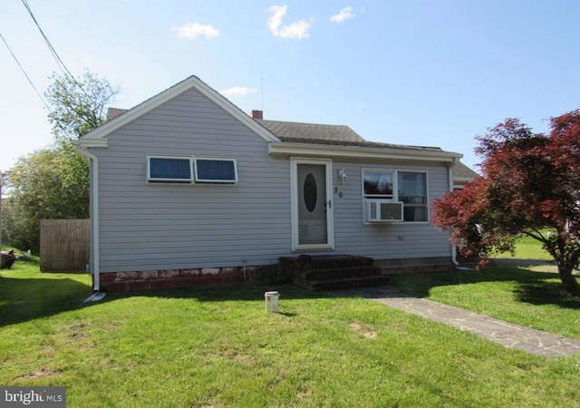 bungalow with cooling unit and a front yard