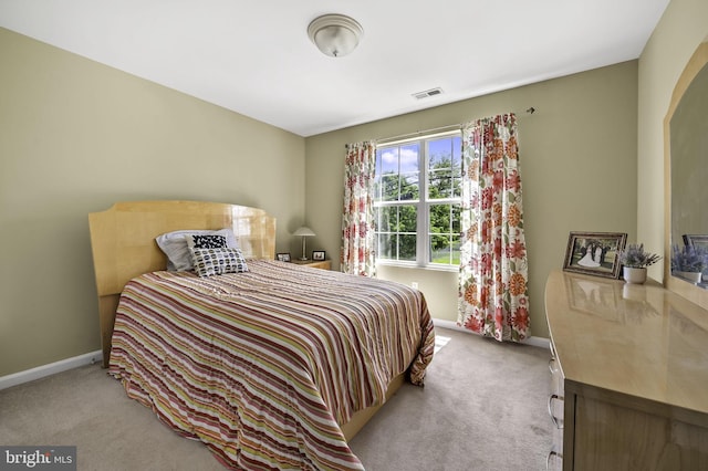 bedroom featuring light colored carpet