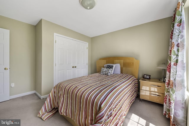 bedroom featuring a closet and light colored carpet