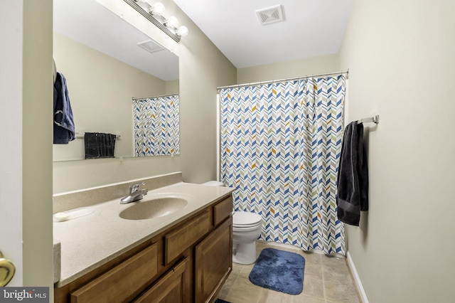 bathroom with tile patterned floors, vanity, and toilet