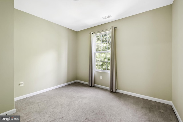 spare room with light carpet