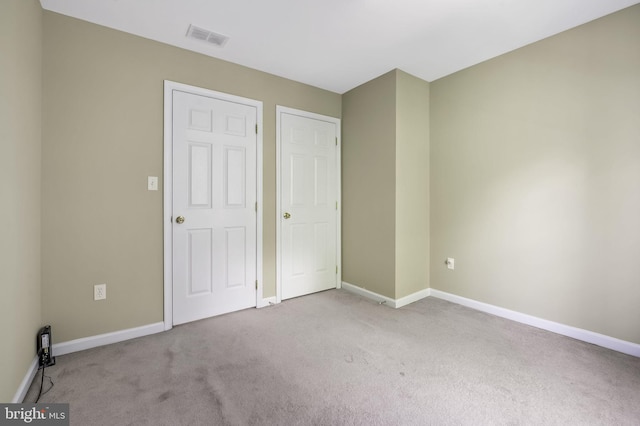 unfurnished bedroom featuring light colored carpet