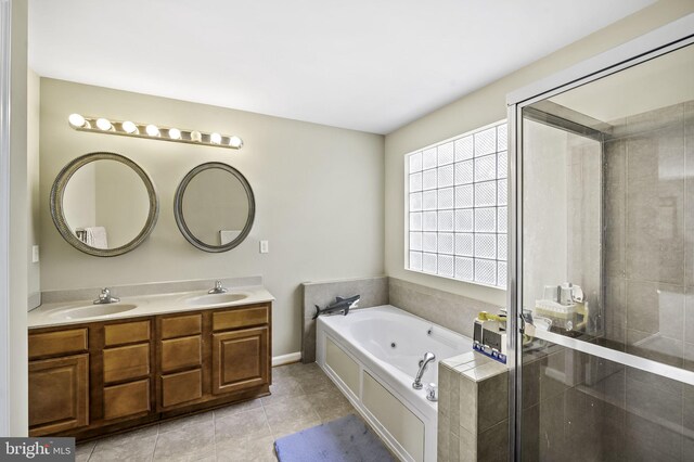 bathroom featuring plus walk in shower, vanity, and tile patterned floors