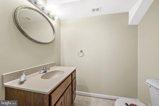 bathroom with tile patterned floors, vanity, and toilet