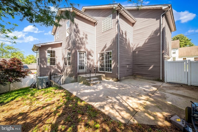 rear view of house with a patio area and central air condition unit