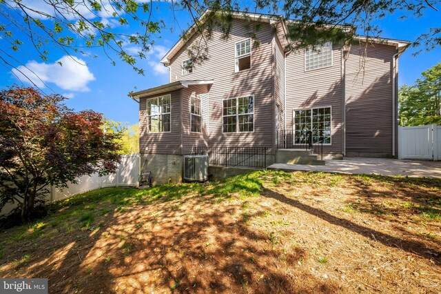 rear view of house featuring central AC and a patio area