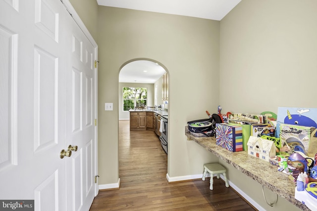 corridor with dark hardwood / wood-style flooring