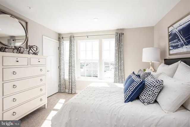 bedroom with light colored carpet