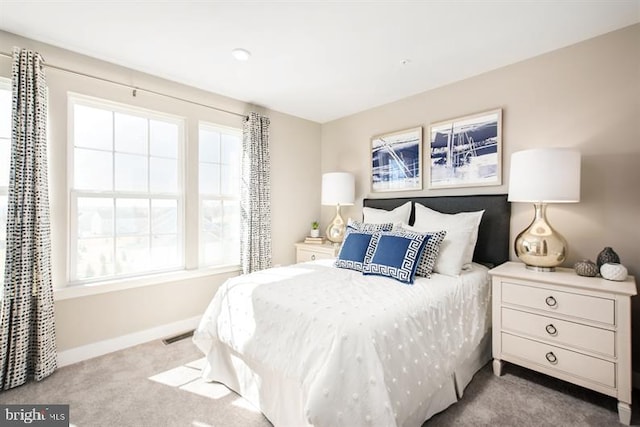 bedroom featuring light carpet