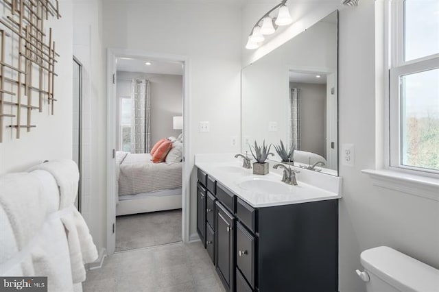 bathroom featuring vanity, toilet, and a shower with door