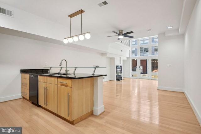 kitchen featuring pendant lighting, black appliances, sink, ceiling fan, and light wood-type flooring