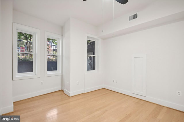 unfurnished room with ceiling fan and light hardwood / wood-style floors