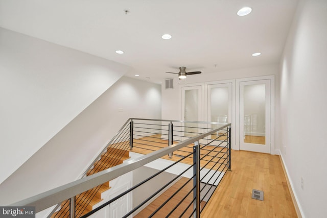 corridor with light hardwood / wood-style floors