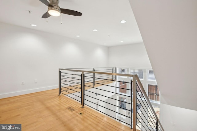 interior space with ceiling fan and hardwood / wood-style floors