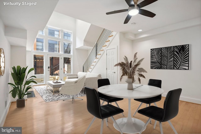 dining space featuring light wood-type flooring and ceiling fan