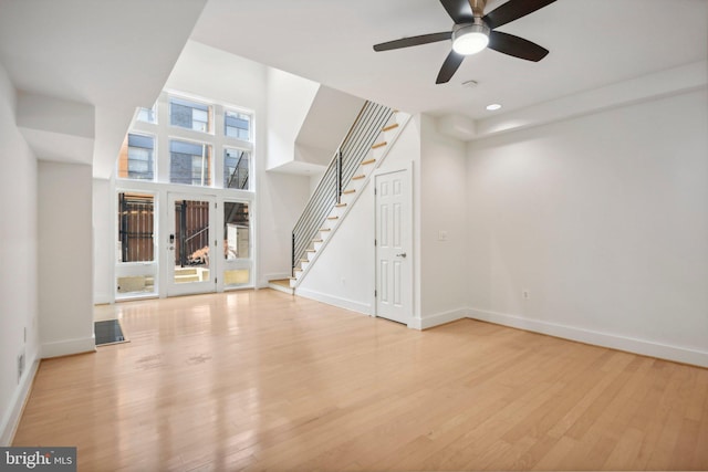 unfurnished living room featuring ceiling fan and light hardwood / wood-style floors