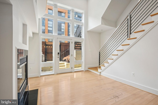 foyer featuring light hardwood / wood-style floors and a high ceiling