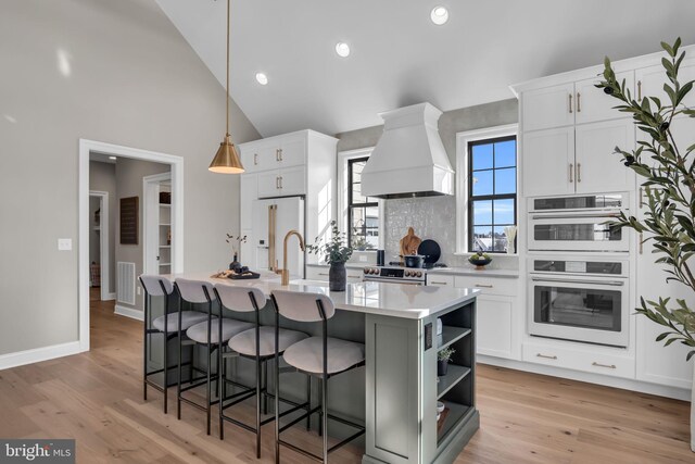 263 Breeches Run Unit 76, Boiling Springs, PA 17007 - kitchen featuring premium range hood, freestanding refrigerator, multiple ovens, open shelves, and light countertops