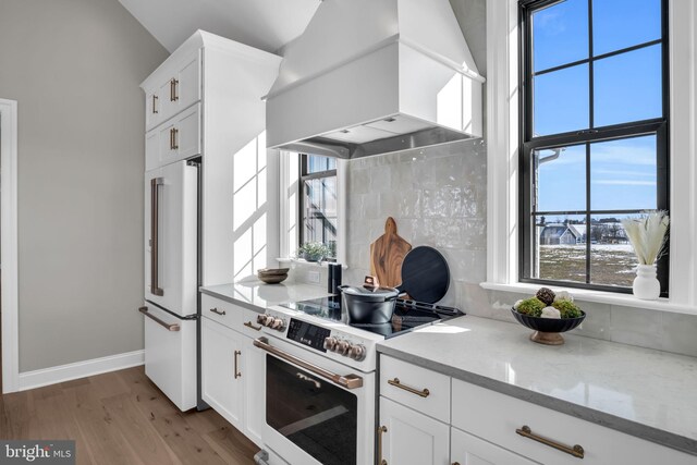 263 Breeches Run Unit 76, Boiling Springs, PA 17007 - kitchen with white appliances, wall chimney exhaust hood, wood finished floors, white cabinetry, and light stone countertops