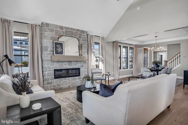 263 Breeches Run Unit 76, Boiling Springs, PA 17007 - living area featuring a chandelier, wood finished floors, a stone fireplace, plenty of natural light, and vaulted ceiling