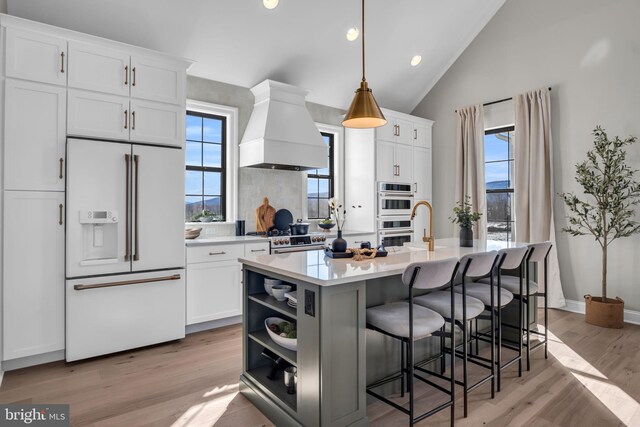 263 Breeches Run Unit 76, Boiling Springs, PA 17007 - kitchen with white appliances, custom range hood, healthy amount of natural light, white cabinetry, and vaulted ceiling