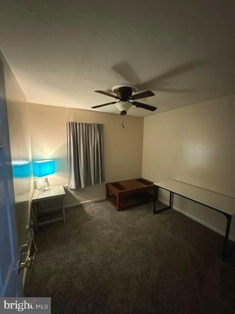 unfurnished bedroom featuring ceiling fan and carpet