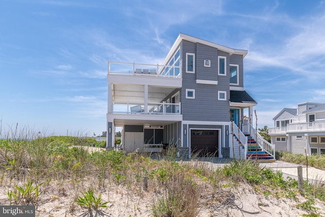 view of front of home featuring a balcony and a garage